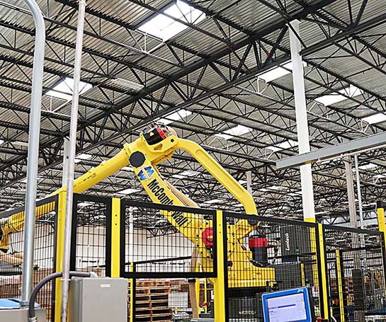 Image of interior of factory with robotic arm