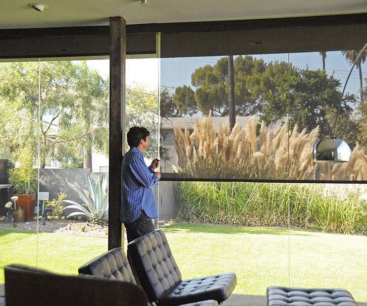 Man enjoying the view outside from the inside of his house