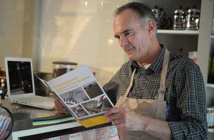 Male business owner looking at brochure