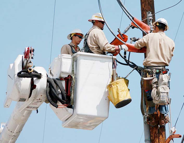 Utility workers repairing a power line