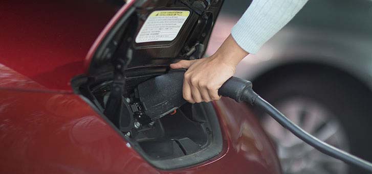 Close up of electric vehicle being charged