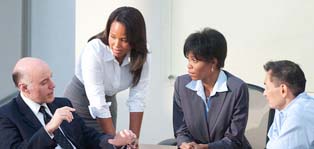 Two men and two women in a conference or meeting
