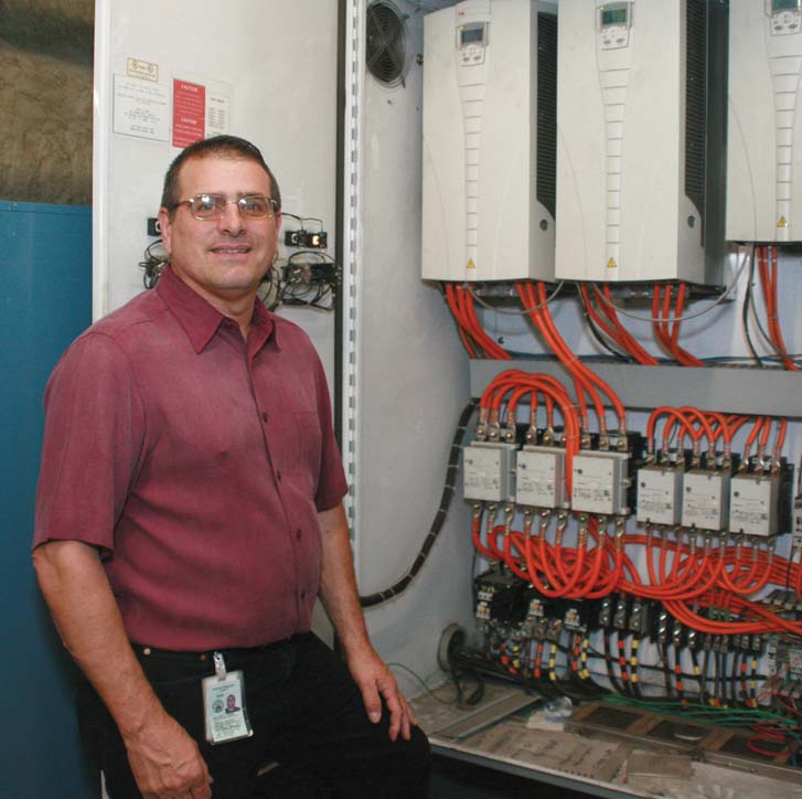 Image of worker in front of control center