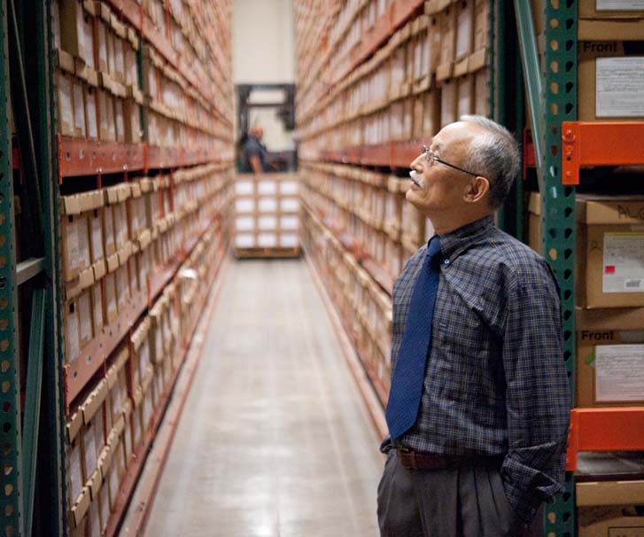 Image of worker looking at boxes