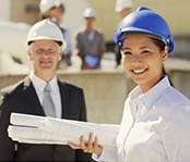 Utitility workers wearing a hard hat smiling, male and female