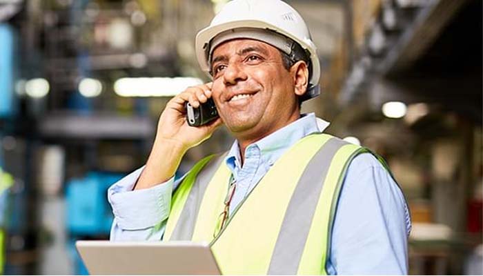 A manager makes a phone call from a warehouse.