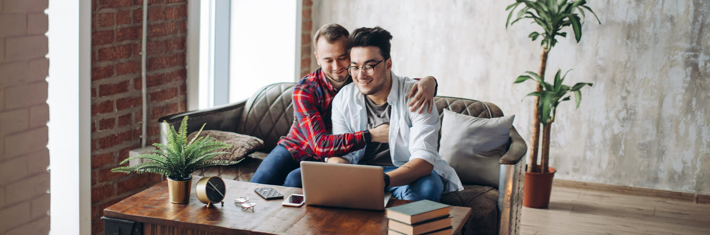 Savings for all hero image of two men looking at computer
