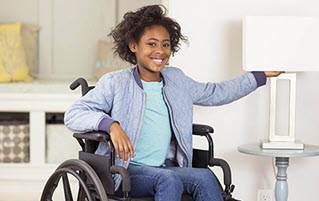 girl in wheelchair turning on lamp