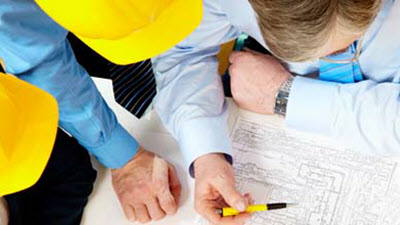 construction contractors reviewing blueprints