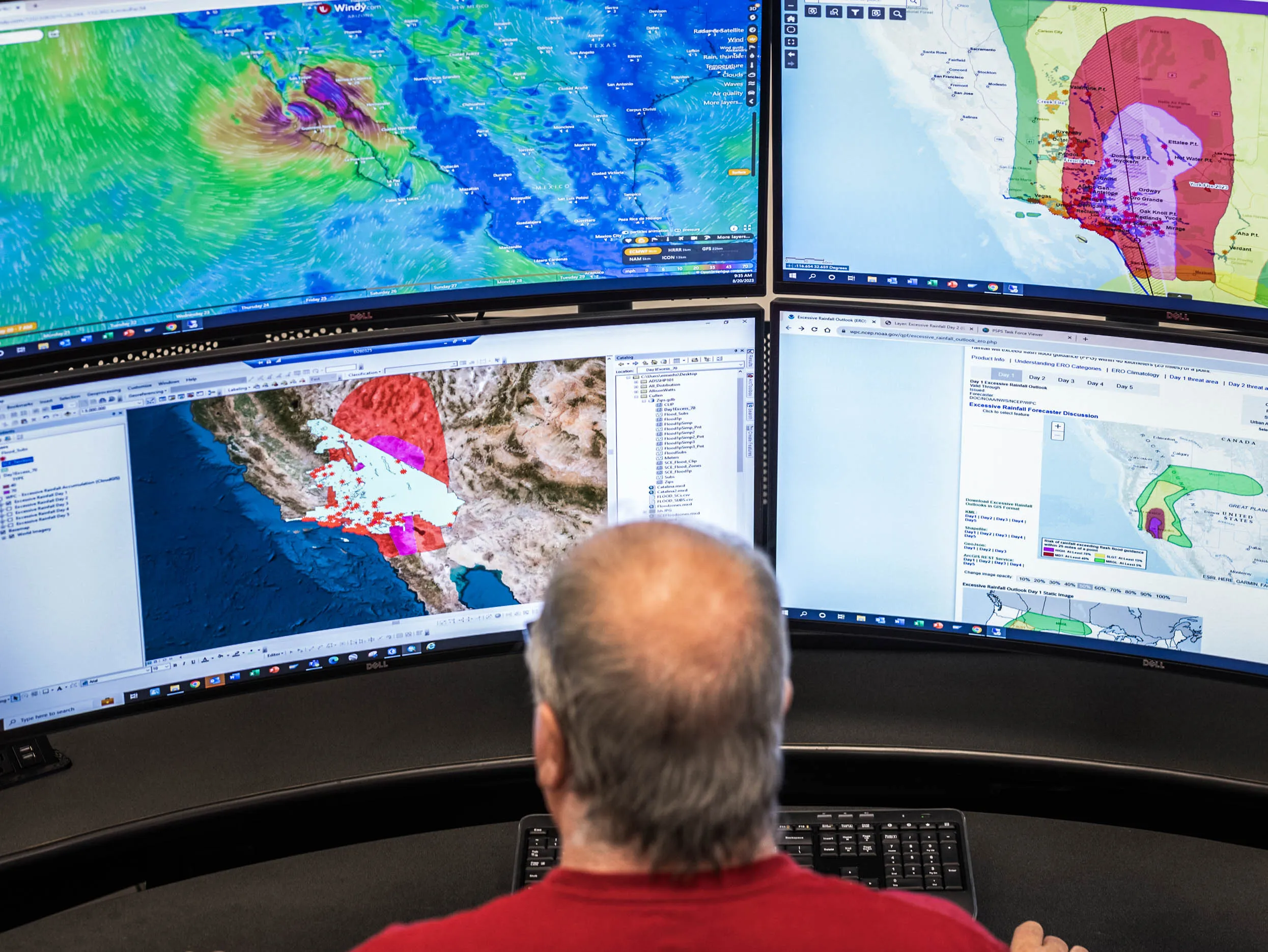 man watching command center for weather events